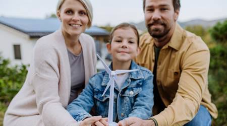 Home happy family holding plastic model of wind turbine 2022 11 02 02 19 50 utc